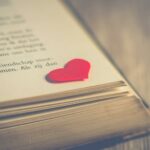 photography of red heart on book page