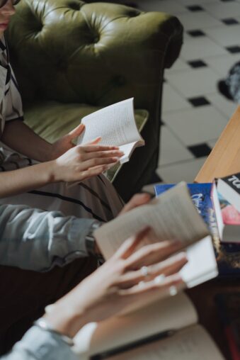 person in gray jacket holding white paper